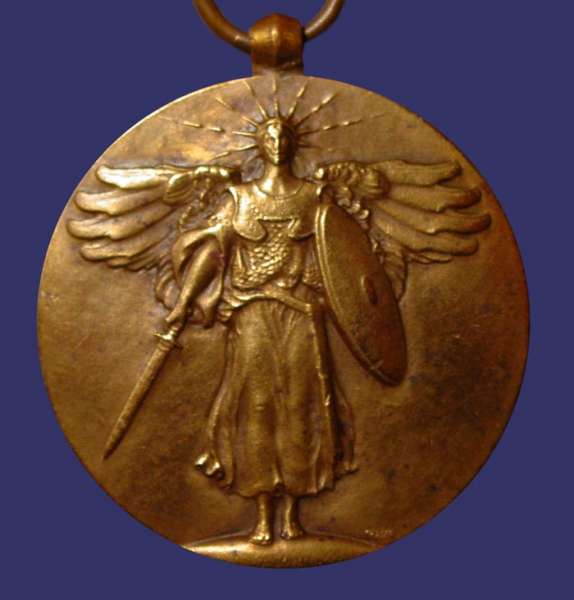 Peace of Versaille, 1919, Obverse
"In 1919 Fraser created a medal memorializing the Peace of Versailles.  On the obverse, a warrior goddess strides toward us wearing a radiant crown and breast plates.  She carries a shield and points her sword down, as a sign that the fighting has been completed.  The figure is vertically-centered, the out-stretched wings offer horizontal opposition.  The background is plain and smooth.  On the reverse the fasce surmounted by the blade of a double-headed battleaxe is seen against the U.S. Shield.  At the top edge of the round the inscription reads THE GREAT WAR FOR CIVILIZATION.  At the bottom, six five-pointed stars are well-spaced.  The participating countries are named and placed on either side of the shield.  On the left they are France, Italy, Serbia, Japan, Montenegro, Russia, and Greece.  On the right they are Great Britain, Belgium, Brazil, Portugal, Rumania, and China.  The overall effect is of clean, modern design.  An earlier version of the face shows only the fasce and battleaxe with four countries, America, France, Britain and Italy, and the date May 1919.  When required to add the names of additional signators of the treaty, Fraser was able to adapt the numerous additional letters to the basic design idea yet still keep his uncluttered feeling."

Quoted from: August L. Freundlich, "The Coins and Medals of James Earle Fraser, In [i]The Medal in America[/i], Edited by Alan M. Stahl, The American Numismatic Society, New York, 1998, pp. 191-193.

