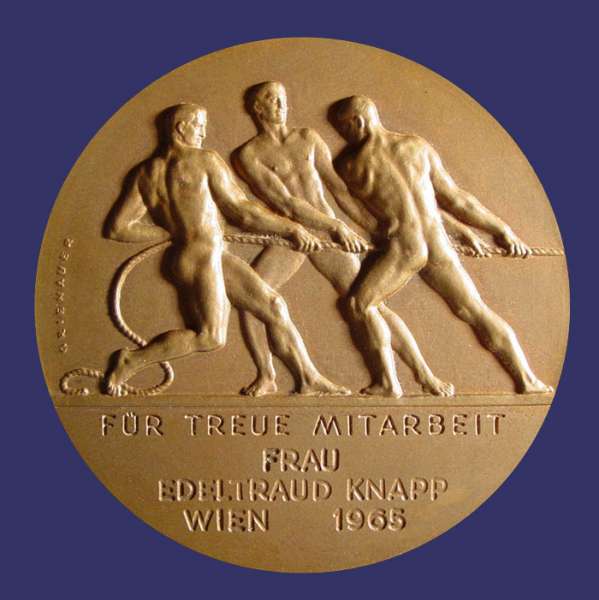 Grienauer, Edwin, Fr Treue Mitarbeit, Reverse, Bronze, 50 mm, Awarded 1965, Reverse
This medal was designed by Edwin Grienauer for the "Kammer Der Gewerblichen Wirtschaft" (Chamber of the Commercial Economy of Vienna).  Edwin Grienauer was one of the more important Viennese Sculptors and Medalist of the 20th Century.  He was born March 7th, 1893 and by 1912, at age 19, he was already creating his first portrait plaques.  His body of work spans more than half a century.  Grienauer worked almost exclusively from commission and was proficient in all areas of sculptural design.  He died on August 21st, 1964.

These medals were issued over many years, exist in different sizes and metal compositions and have individualized dedications located below the three men on the reverse.  They were awarded for lengthy terms of service.

The obverse depicts Mercury carrying  a caduceus and a wreath.  In the background are the smoke stacks of industry at a riverside (Vienna is divided by the Danube River).  Across the bottom is inscribed "Fr Wien" and around the rim, "Kammer Der Gewerblichen Wirtschaft" (Chamber of the Commercial Economy of Vienna).  The reverse depicts three men in a classical style cooperating in pulling a load.   Below the image is the inscription "Fr Treue Mitarbeit" (For Loyal Dedication) "Frau Edeltraud Knapp Wien 1965" (Mrs. Edeltraud Knapp, Vienna 1958).

The medal work of Grienauers consists mainly of commissioned pieces for his customers and this aspect of his work is dominated by award/service medals of national or economic institutions and prizes for sporting events.  His large sculptures are still present today in Vienna and include reliefs and architectural sculptures, crucifixes and religious statues on and in Viennese churches, and even floor tiles for the St Stephans Cathedral.

Works include coinage dies of the Austrian 1st and 2nd Republic, medals, sculptures, and portraits.  He designed commemorative and regular issue coins for Liechtenstein as well.  Grienauer designed the denomination side of the last of the Schilling coins of Austria, which were in circulation from 1959 to 2002.

Keywords: art_deco_page nude male birks_nude_male