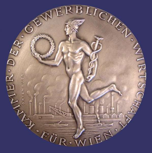 Fr Treue Mitarbeit, Silvered Bronze, 70 mm, Awarded 1974, Reverse
[b]From the collection of John Birks[/b]

This medal was designed by Edwin Grienauer for the "Kammer Der Gewerblichen Wirtschaft" (Chamber of the Commercial Economy of Vienna).  Edwin Grienauer was one of the more important Viennese Sculptors and Medalist of the 20th Century.  He was born March 7th, 1893 and by 1912, at age 19, he was already creating his first portrait plaques.  His body of work spans more than half a century.  Grienauer worked almost exclusively from commission and was proficient in all areas of sculptural design.  He died on August 21st, 1964.

These medals were issued over many years, exist in different sizes and metal compositions and have individualized dedications located below the three men on the reverse.  They were awarded for lengthy terms of service.

The obverse depicts Mercury carrying  a caduceus and a wreath.  In the background are the smoke stacks of industry at a riverside (Vienna is divided by the Danube River).  Across the bottom is inscribed "Fr Wien" and around the rim, "Kammer Der Gewerblichen Wirtschaft" (Chamber of the Commercial Economy of Vienna).  The reverse depicts three men in a classical style cooperating in pulling a load.   Below the image is the inscription "Fr Treue Mitarbeit" (For Loyal Dedication) "Frau Edeltraud Knapp Wien 1965" (Mrs. Edeltraud Knapp, Vienna 1958).

The medal work of Grienauers consists mainly of commissioned pieces for his customers and this aspect of his work is dominated by award/service medals of national or economic institutions and prizes for sporting events.  His large sculptures are still present today in Vienna and include reliefs and architectural sculptures, crucifixes and religious statues on and in Viennese churches, and even floor tiles for the St Stephans Cathedral.

Works include coinage dies of the Austrian 1st and 2nd Republic, medals, sculptures, and portraits.  He designed commemorative and regular issue coins for Liechtenstein as well.  Grienauer designed the denomination side of the last of the Schilling coins of Austria, which were in circulation from 1959 to 2002.

Keywords: nude male gay