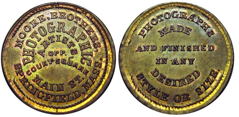 JAB-21  MOORE BROTHERS PHOTOGRAPHY  Copper on GB Token
28mm - 5 Struck

Both dies were cut in 1865.  It is presumed they were given to the Moore Brothers and are currently unaccounted for.

The Moore Brothers were jointly in Business at 441 Main Street in Springfield, Mass. from 1859 through 1877. During the Civil War, they photographed every new recruit from Springfield and provided copies at no charge. Between the two Brothers, they amassed more than 80,000 negatives.


The example pictured was acquired in the August 2015 Hayden Sale, lot 612.  It was struck over a Great Britain Token and the edge lettering "PAYABLE IN LONDON" is clearly visible.  
